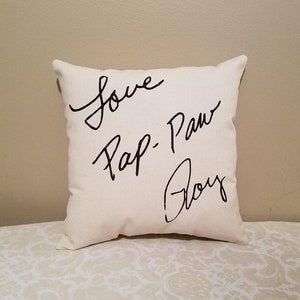 May include: White throw pillow with black cursive writing that says "Love Pap-Paw Boy"