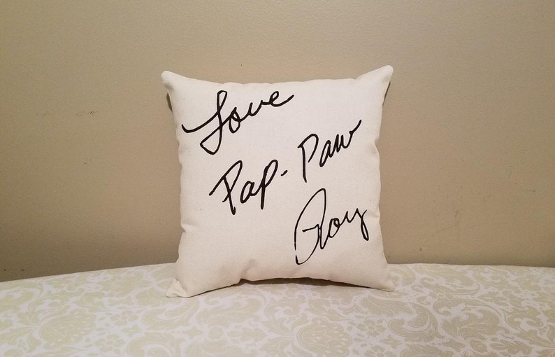 May include: White throw pillow with black cursive writing that says "Love Pap-Paw Boy"