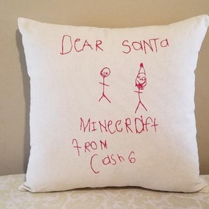 May include: White pillow with red writing that says "Dear Santa Minecraft from Cash 6" with stick figure drawings of a person and Santa Claus.