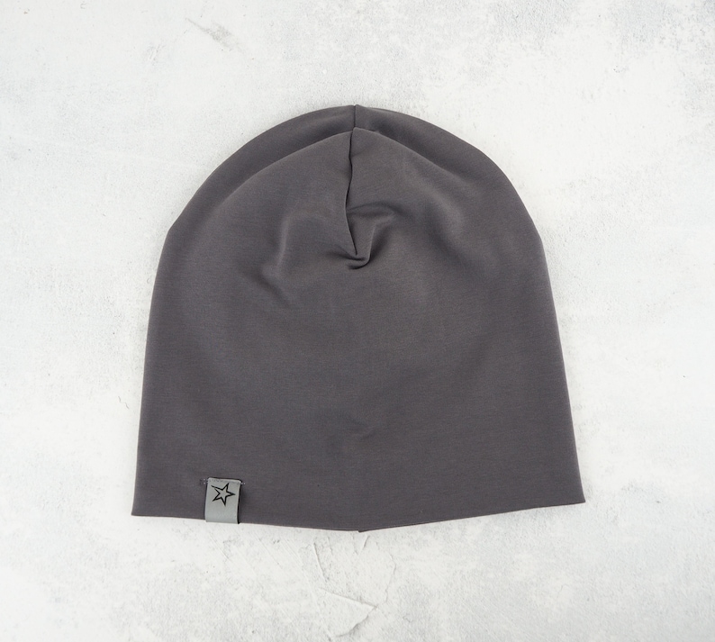 May include: A dark gray beanie with a small star logo on the side.