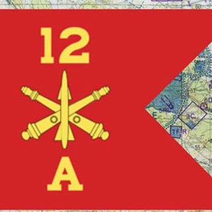 May include: A red flag with a yellow design and text. The flag features the number "12", the letter "A", and a central emblem with a star and cannons. A map is visible in the background.