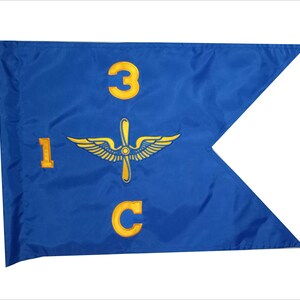 May include: A blue pennant flag with yellow embroidered details. The flag features the numbers "1", "3", and "C", along with a propeller and wing design. The flag is likely used for military or aviation purposes.