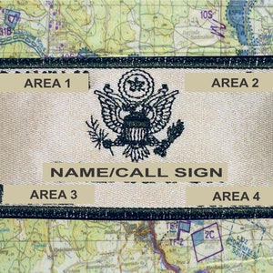 May include: A rectangular patch with a black border and tan background, featuring the text "AREA 1", "AREA 2", "AREA 3", and "AREA 4". The center displays a detailed emblem of an eagle with a banner that reads "NAME/CALL SIGN". The background is a map.