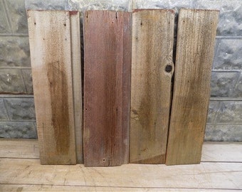 May include: Four reclaimed wood planks, each with a different grain pattern and color variation. The planks are weathered and have a rustic appearance.