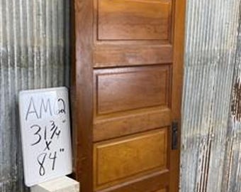 May include: A solid wood door with six panels, a small metal plate, and a metal door handle. The door is 31 1/2 inches by 84 inches.