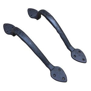 May include: Two black metal door handles with a pointed, teardrop-shaped design. The handles have a curved shape and are designed for pulling open doors.