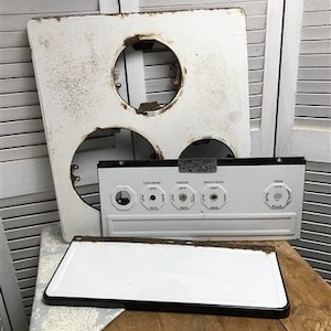 May include: White enamel stovetop with three burner openings and a control panel with labels for "Left Front", "Center", "Right Front", and "Oven".