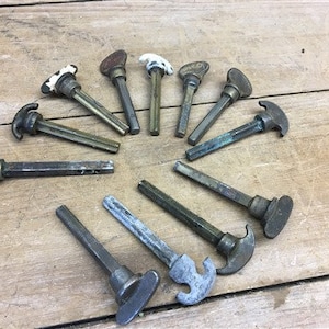 May include: A collection of 10 antique brass door knobs with various styles and designs. The knobs are all in good condition and have a patina finish.