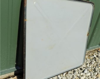 May include: A white metal sign with a black border. The sign is blank and has a slight curve to it.