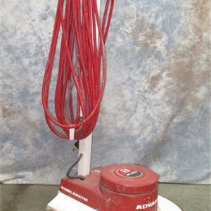 May include: A red and white floor polisher with a long red cord. The polisher has a black handle and a white base. The brand name "Advance" is visible on the side of the polisher.
