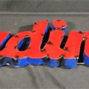 May include: Red and blue metal sign with the word "Cardinals" in raised letters. The letters have a distressed look, with some of the paint chipped away.