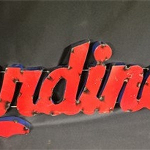 May include: A red and blue metal sign with the word "Cardinals" in a vintage style font.