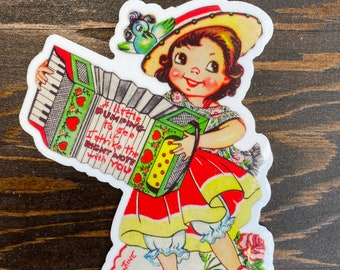 3 inch high valentine girl playing accordion.