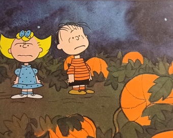 May include: A cartoon illustration of two children standing in a field of pumpkins. The girl is wearing a blue dress with white polka dots and has yellow hair. The boy is wearing a striped orange and black shirt and black pants. The background is a dark blue sky with white clouds.