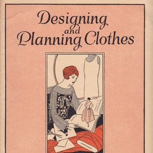 May include: A vintage book cover with an illustration of a woman designing clothes. The book title is "Designing and Planning Clothes" and it was published by Woman's Institute of Domestic Arts & Sciences, Inc. in Scranton, Pennsylvania.