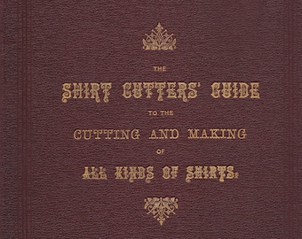 May include: A burgundy leather-bound book with gold lettering on the cover. The title is "The Shirt Cutters' Guide to the Cutting and Making of All Kinds of Shirts."