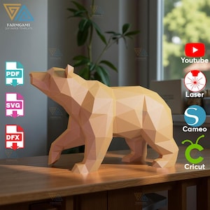 May include: A geometric paper bear sculpture in shades of tan stands on a wooden surface. The bear is made from multiple flat, angled planes, giving it a polygonal appearance. The image includes logos for PDF, SVG, and DFX file formats.