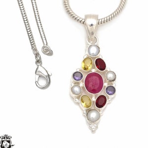 May include: A silver necklace with a pendant featuring a cluster of colorful gemstones, including red, yellow, purple, and white. The pendant is shaped like a diamond and has a delicate, ornate design.