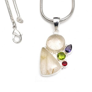 May include: Silver necklace with a pendant featuring a clear quartz stone with gold inclusions. The pendant is accented with four small gemstones: green, red, and two purple.