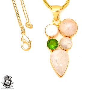 May include: Gold chain necklace with a pendant featuring a cluster of white and green gemstones. The pendant is shaped like a teardrop and has a delicate design.