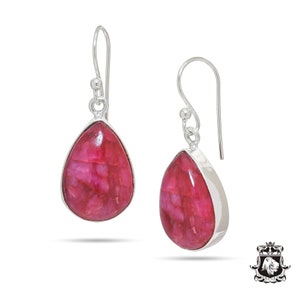 May include: A pair of silver dangle earrings with teardrop-shaped pink stones.