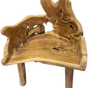 May include: A unique, handcrafted wooden bench with a natural, organic design. The bench features a light brown color with visible wood grain and two sturdy legs. The seat has an irregular shape, showcasing the natural form of the wood.