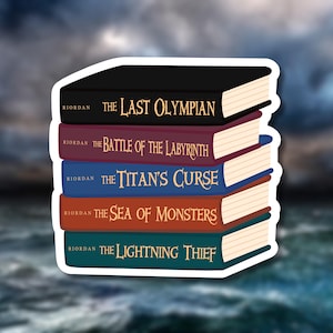 May include: A sticker featuring a stack of five books from the Percy Jackson series. The books are in various colors, including black, burgundy, blue, orange, and teal. Each book has a title and the author's name, Riordan, printed on the spine.