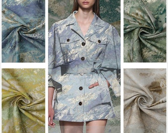 May include: Close-up of four fabric swatches with a metallic sheen and abstract patterns in shades of blue, green, yellow, and beige.