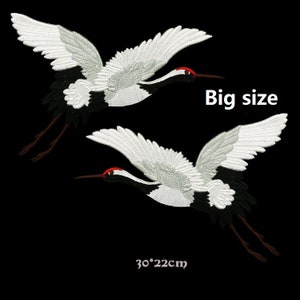 May include: Two white embroidered crane patches with black and red accents. The patches are 30 inches by 22 inches.