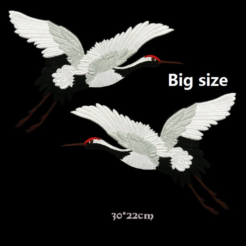 May include: Two white embroidered crane patches with black and red accents. The patches are 30 inches by 22 inches.