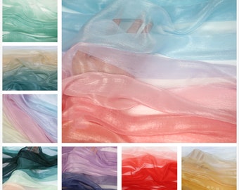 May include: Assortment of ombre sheer fabric in various colors, including green, blue, pink, purple, red, and gold. The fabric is translucent and has a subtle shimmer.