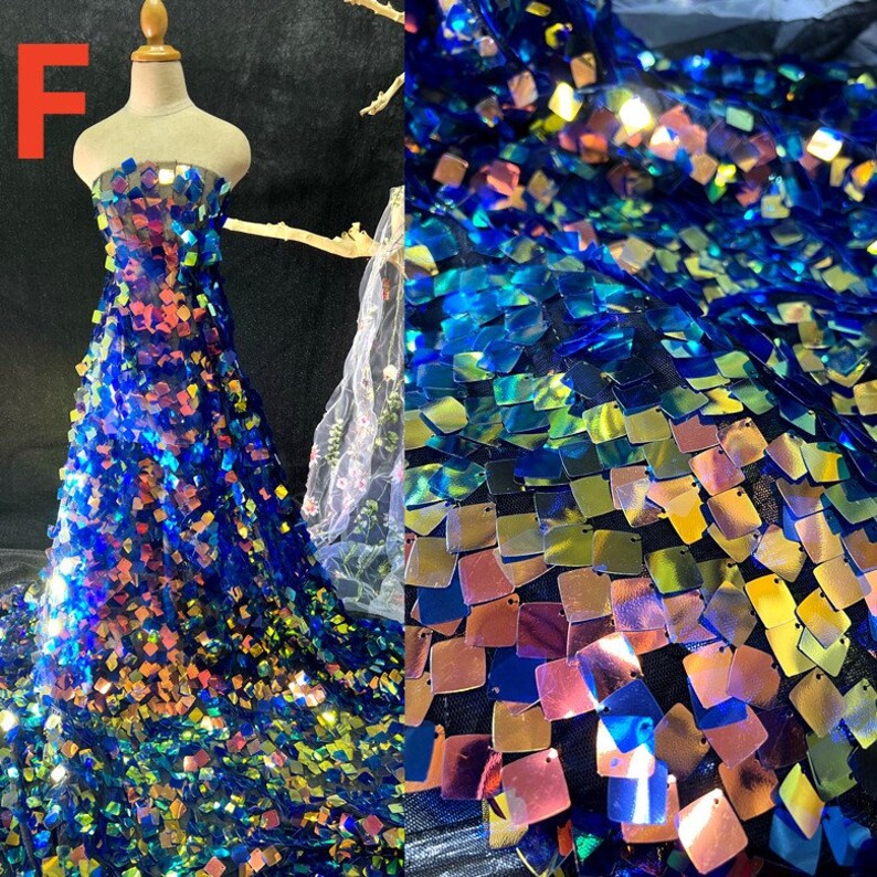 May include: A strapless gown made of blue fabric covered in iridescent square sequins. The sequins reflect colors like gold, pink, and green. The dress is displayed on a mannequin. The letter "F" is in the upper left corner.