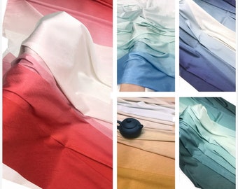 May include: Five different ombre fabric swatches in various colors, including red, blue, green, and yellow. The fabric has a subtle texture and a gradient color effect.