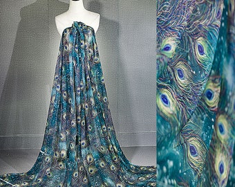 May include: A bolt of fabric draped over a mannequin, featuring a peacock feather design. The fabric is primarily teal and blue, with accents of yellow and white. The pattern is detailed and intricate, with a flowing, elegant drape.