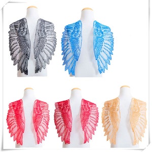 May include: Set of six pairs of angel wings in various colors, including black, blue, red, and gold. The wings are made of lace and are designed to be sewn onto clothing or other items.
