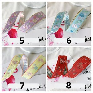 May include: Four decorative ribbons with floral and butterfly patterns. The ribbons are in shades of purple, blue, yellow, and red. Each ribbon has a different design and color scheme, with gold trim. Numbers 5, 6, 7, and 8 are visible on the image.