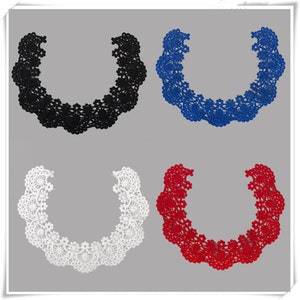 May include: Four lace collars in different colors: black, blue, white, and red. Each collar is a U-shaped design with intricate floral patterns.