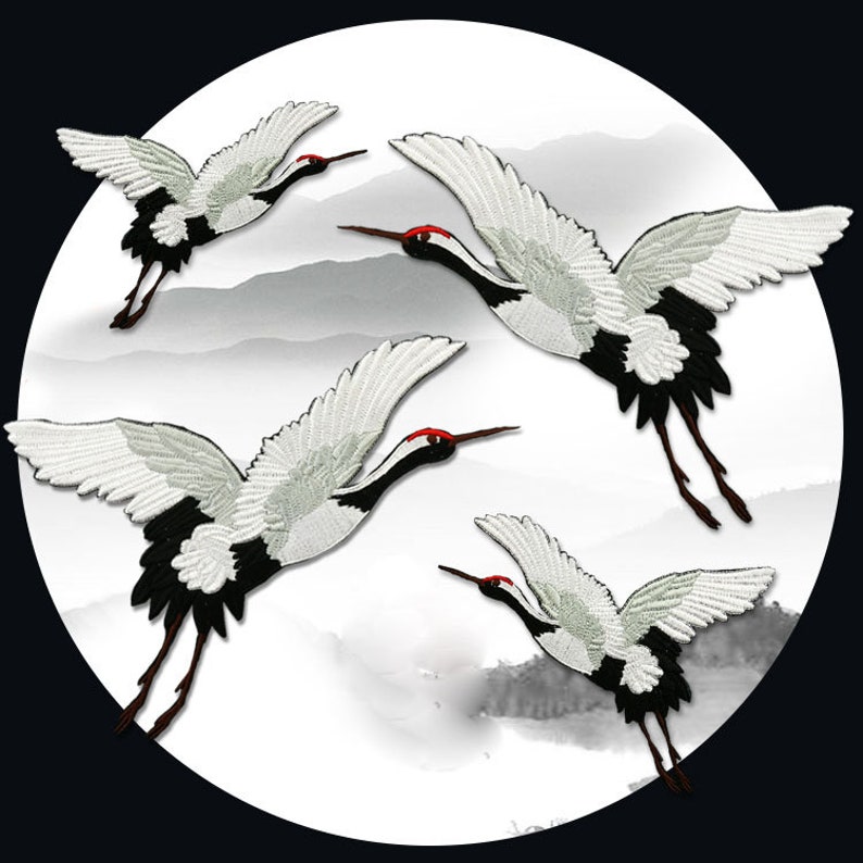 May include: Four white and black embroidered crane patches with red beaks. The cranes are flying in a white and gray cloudy background.