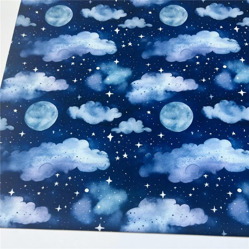 May include: A seamless pattern featuring watercolor clouds and moons on a dark blue background. The clouds are light blue and white, and the moons are a light blue color. The pattern is perfect for fabric, wallpaper, or wrapping paper.