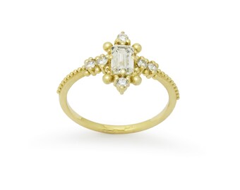 Victorian-Inspired Gold Ring with Centered Emerald-Cut Diamond and Accent Diamonds
