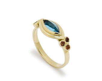 Gold ring with Marquise Topaz and Garnet Accents