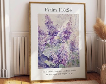 May include: A framed watercolor painting of purple lilac flowers with a quote from Psalm 118:24, "This is the day that the Lord has made; let us rejoice and be glad in it."