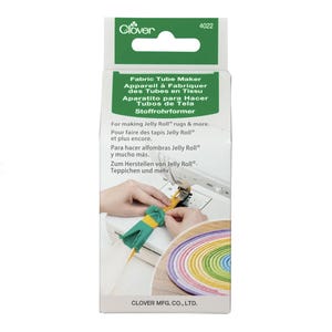 May include: A Clover Fabric Tube Maker package. The package is white with green accents and features text in multiple languages. The image shows the tool in use, creating a fabric tube. The tool is designed for making Jelly Roll rugs and more.