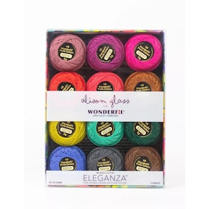 May include: A set of 12 WonderFil Eleganza #8 perle cotton thread balls in a clear display box. The collection features various colors including pink, red, orange, yellow, green, blue, and brown. Each ball is 5g and 42 yards long.