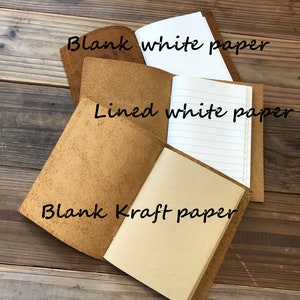 May include: A brown leather notebook with four different paper options: blank white paper, lined white paper, blank kraft paper, and blank white paper.