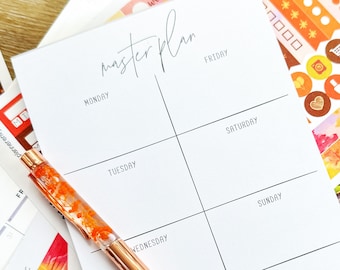 May include: A white weekly planner with the words "master plan" written at the top. The planner is divided into seven sections for each day of the week. A gold pen with orange glitter inside is lying on top of the planner. The planner is surrounded by colorful stickers with fall-themed designs.