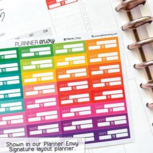 May include: Colorful planner stickers with "Work" and "TO" labels in various colors, including red, green, and purple. The stickers are shown on a planner page with the text "Planner Envy".