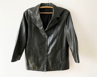 May include: A black leather jacket with a button closure and two pockets. The jacket has a collar and long sleeves.