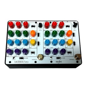 May include: A white and black effects pedal with the text "MOTHER Para" and "sine effect". The pedal has a rainbow of knobs with labels such as "FRQ", "GAIN", "Q", "HPF", "LO SHAPE", "HI SHAPE", "MID", "PHASE", "LPF", "VOL I", "VOL II", "GND LIFT", "ACTIVE", "IN GAIN", and "BYPASS".