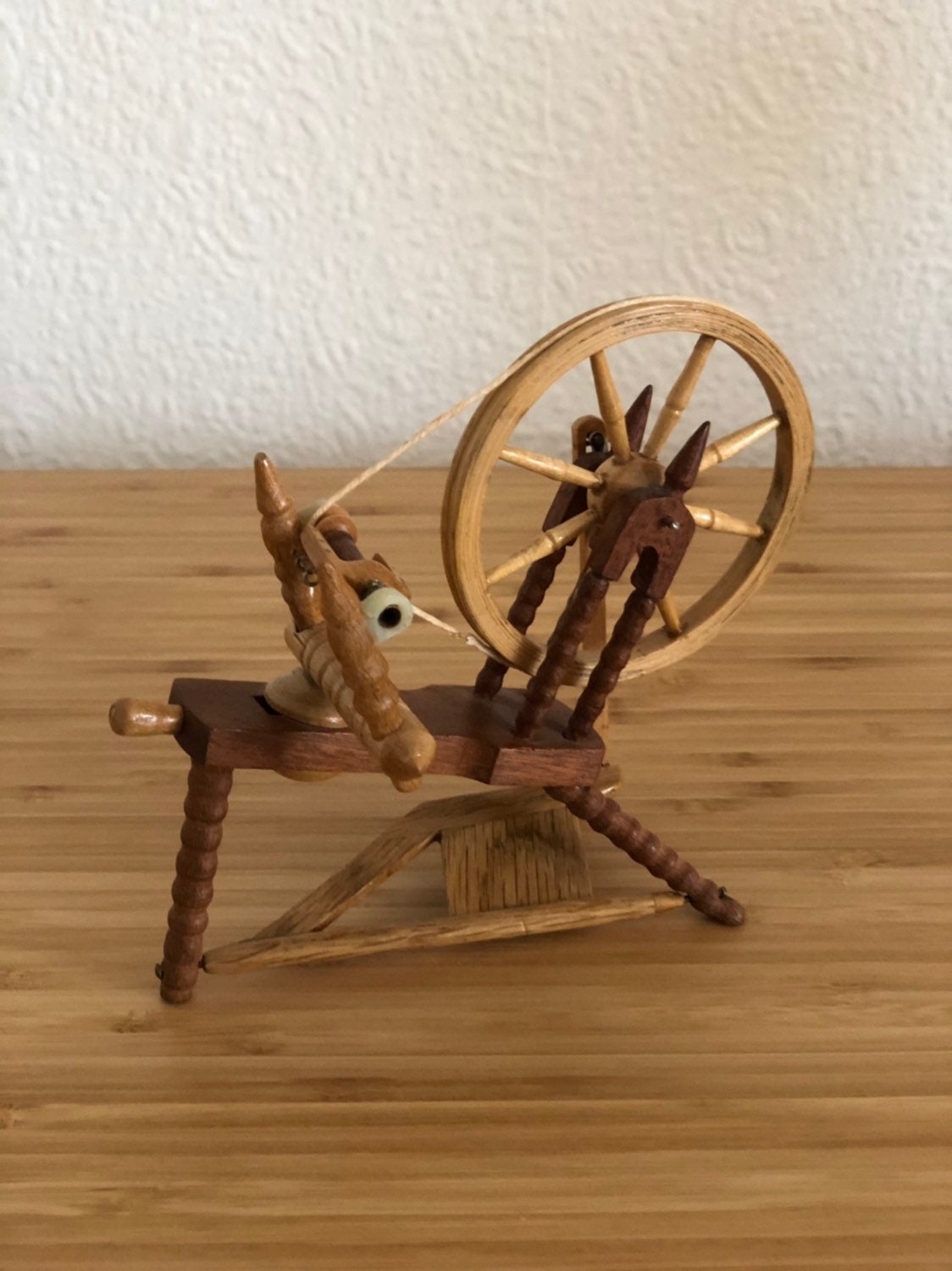 Miniature hand carved wooden spinning wheel with working wheel and pedal